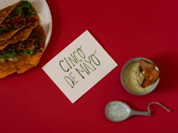 a plate of food sitting on top of a red table, inspired by Ceferí Olivé, graffiti, taco, cards, on grey background, mayo