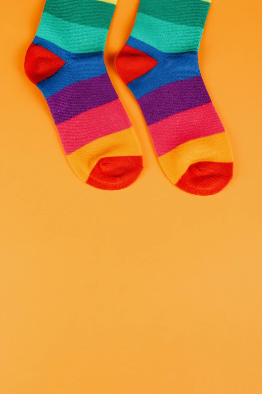 a pair of colorful socks on an orange background, trending on pexels, color field, colorful]”, conor walton, low detail, multilayer