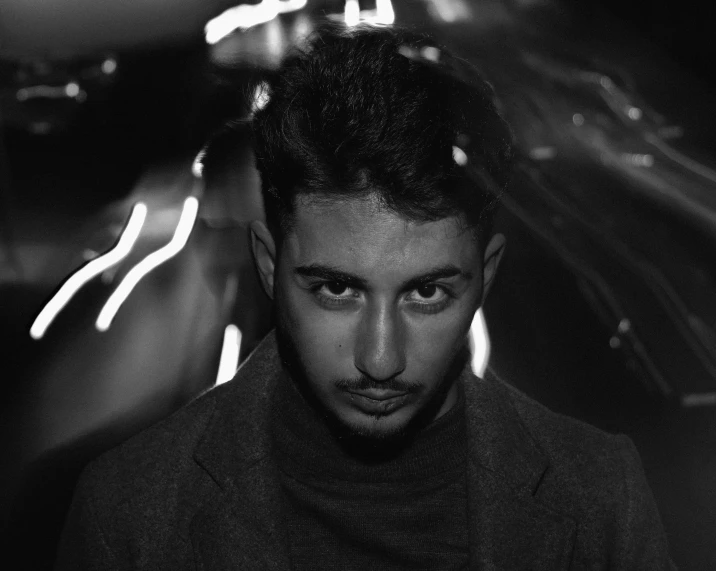 a man standing in front of a car at night, a black and white photo, by Ismail Acar, discord profile picture, good looking face, flume, zaha hadi