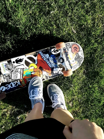 a person sitting in the grass with a skateboard, profile image