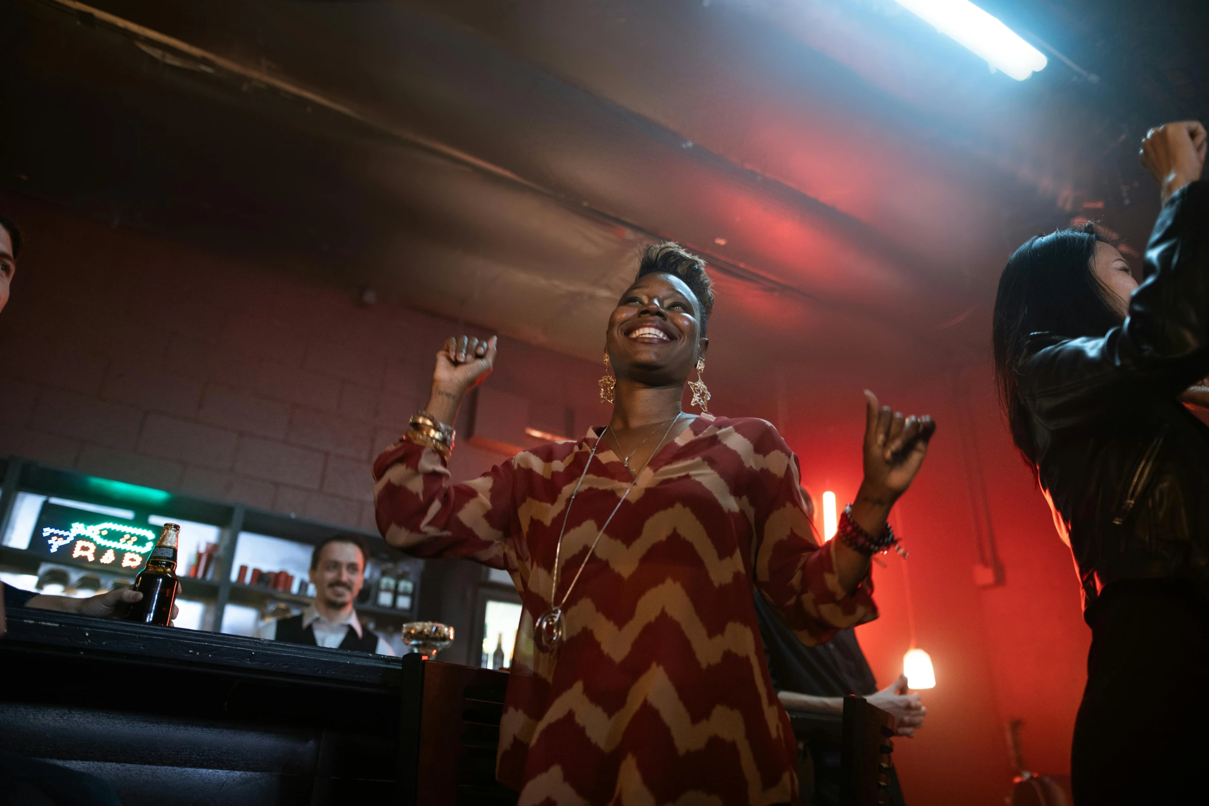 a group of people that are standing in a room, grace jones, in a bar, she expressing joy, shot on sony a 7