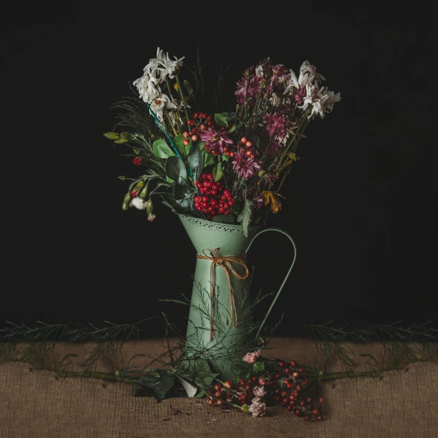 a vase filled with flowers sitting on top of a table, a still life, inspired by Elsa Bleda, pexels contest winner, red green black teal, holiday season, watering can, wrapped in flowers and wired