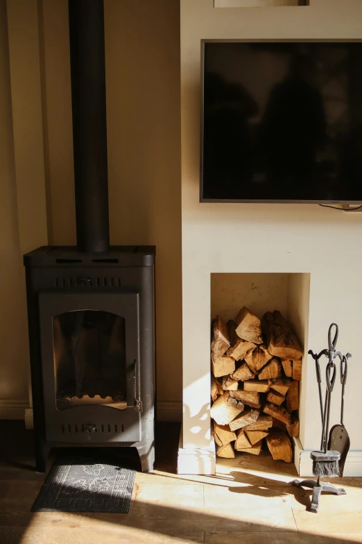 a living room with a fire place and a television, a picture, unsplash, light and space, cottage close up, stove, a high angle shot, very aesthetically pleasing