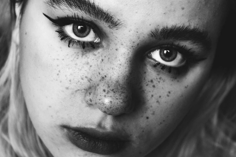 a close up of a woman with freckles on her face, a black and white photo, pexels, hyperrealism, 🤤 girl portrait, large eyebrows, hyperrealistic teen, starry eyes