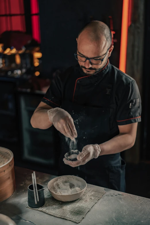 a man standing in a kitchen preparing food, inspired by Wlodzimierz Tetmajer, scales with magic powder, aussie baristas, deep texture, raku