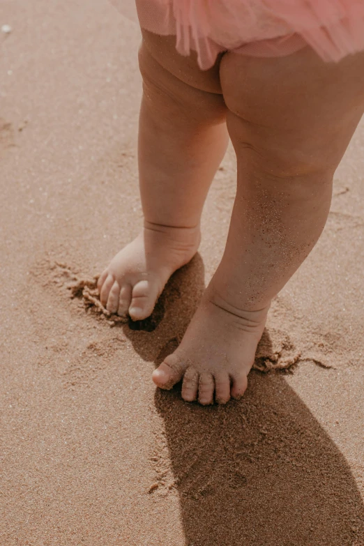 a baby standing on top of a sandy beach, by Arabella Rankin, unsplash, renaissance, shows a leg, an obese, 15081959 21121991 01012000 4k, visible pores