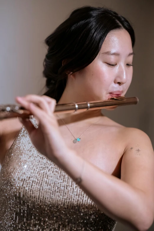 a woman in a silver dress playing a flute, inspired by Zheng Xie, unsplash, jaeyeon nam, square, 8 k ), sweaty