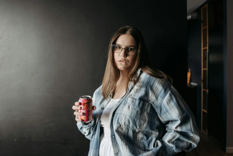 a woman with glasses holding a can of soda, by Thomas Furlong, pexels contest winner, confident pose, pokimane, lachlan bailey, pbr