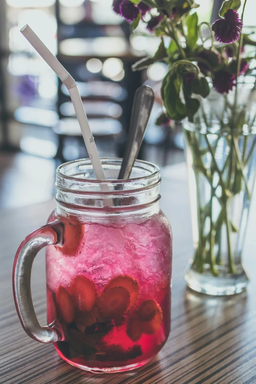 a mason jar sitting on top of a table next to a vase of flowers, a photo, unsplash, cold drinks, magenta, restaurant menu photo, texture