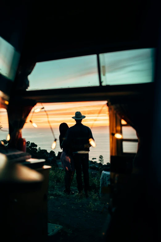 a couple of people standing in front of a truck, by Lee Loughridge, unsplash contest winner, renaissance, overlooking the ocean, glamping, back lit, shot on hasselblad