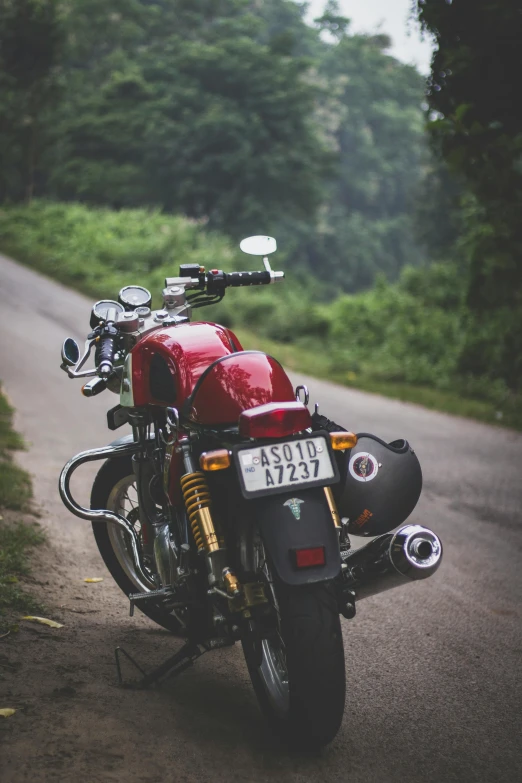 a red motorcycle parked on the side of a road, pexels contest winner, renaissance, assamese aesthetic, lower back, triumph, curls