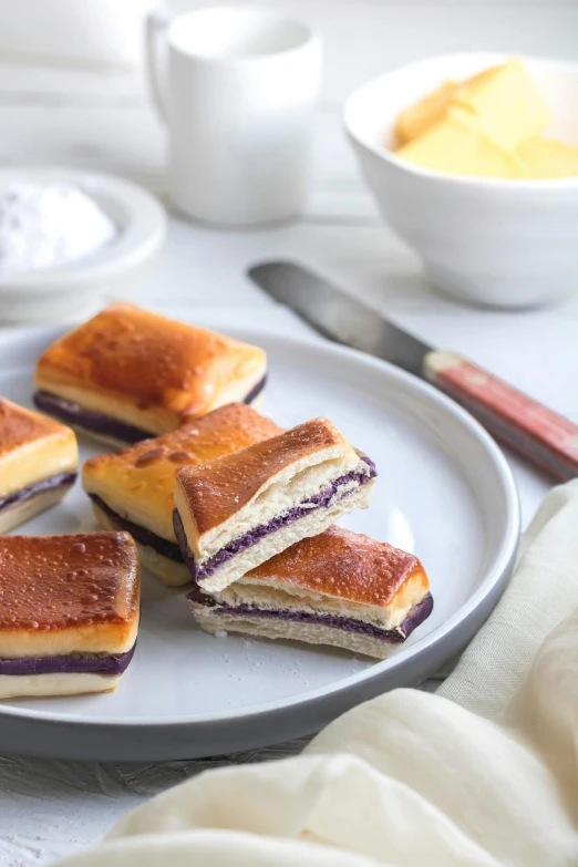 a close up of a plate of food on a table, white and purple, kek, squares, layered