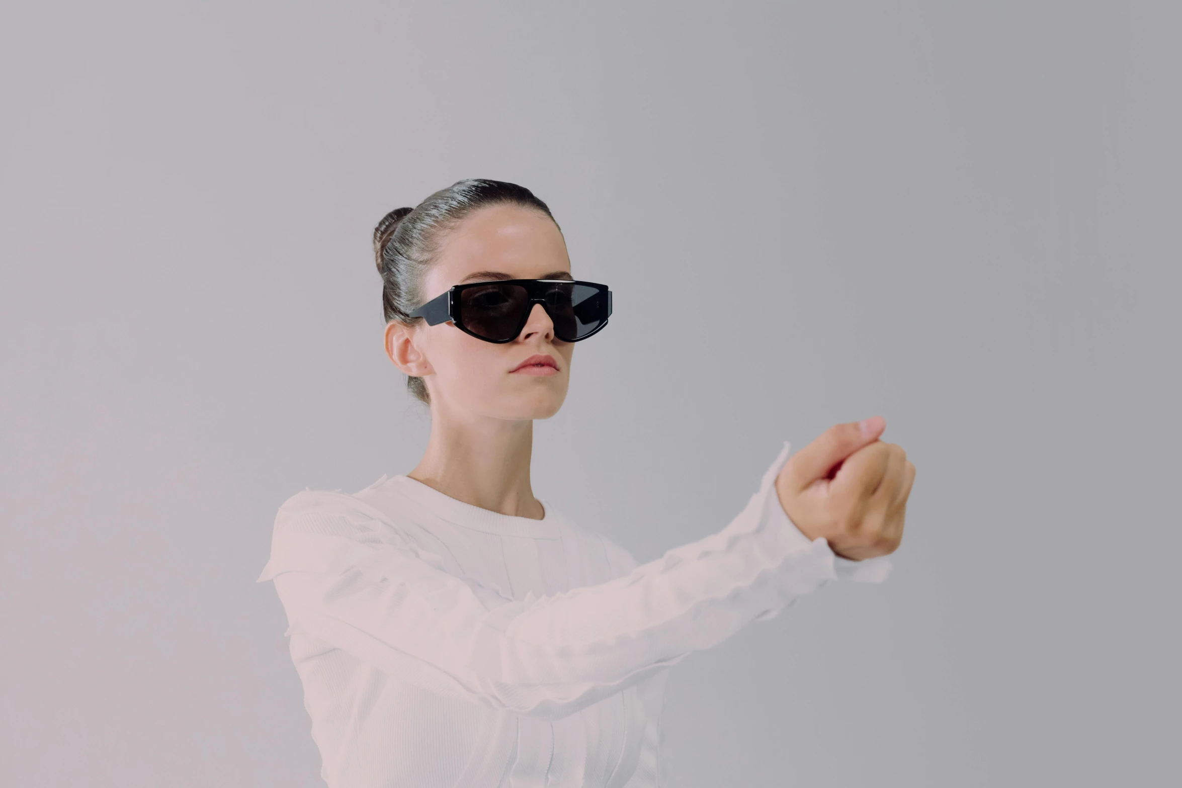 a woman in a white shirt and black sunglasses, a hologram, inspired by Anna Füssli, interactive art, battle pose, 3 d nft, pointing at the camera, natali portman