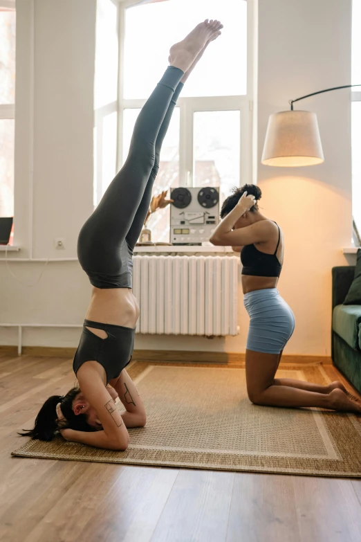 two women doing a handstand pose in a living room, by Matija Jama, arabesque, high quality upload, multi-part, profile pic, lotus pose