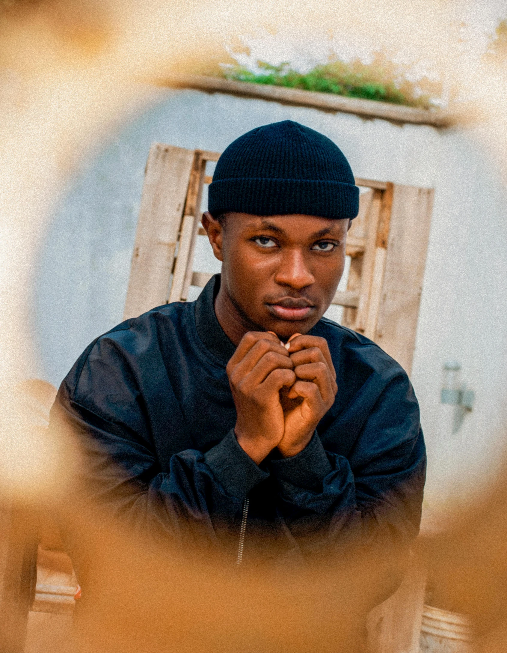 a man that is standing in front of a mirror, an album cover, inspired by Barthélemy Menn, trending on pexels, thoughtful pose, ( ( dark skin ) ), thin young male, he is wearing a hat