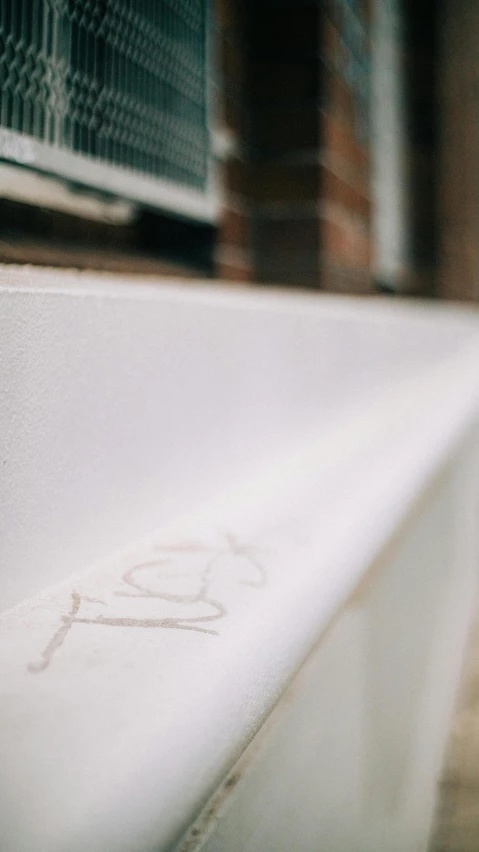 a white bath tub sitting on top of a tiled floor, inspired by Rachel Whiteread, unsplash, graffiti, low - angle shot, banner, sitting on bench, low quality photo