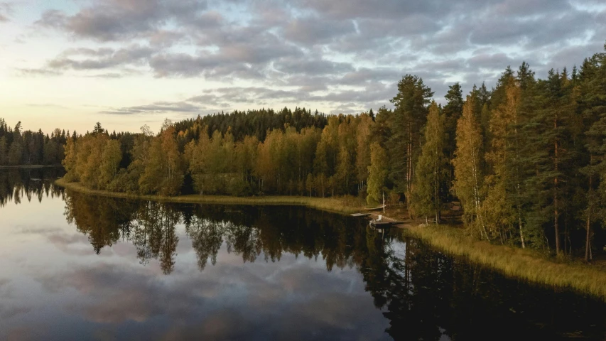 a body of water surrounded by trees under a cloudy sky, by Eero Järnefelt, pexels contest winner, hurufiyya, autumn light, late summer evening, panorama, afternoon hangout