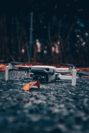 a small white drone sitting on the ground, a picture, pexels contest winner, fall season, electronics, iconic design, mid portrait