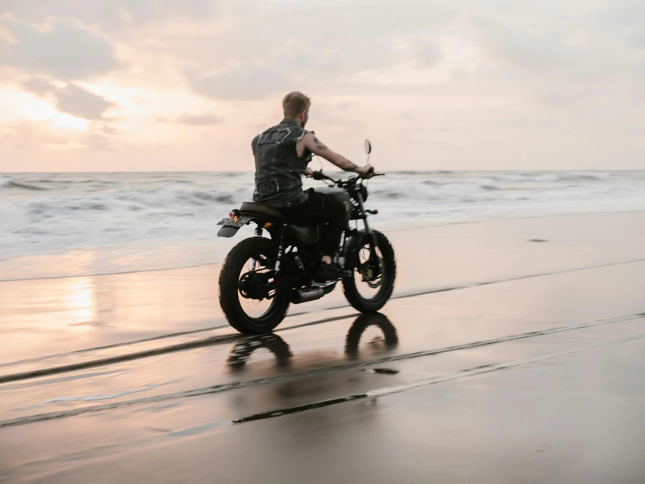 a man riding a motorcycle on a wet beach, by Daniel Seghers, pexels contest winner, avatar image, fine details, student, profile image