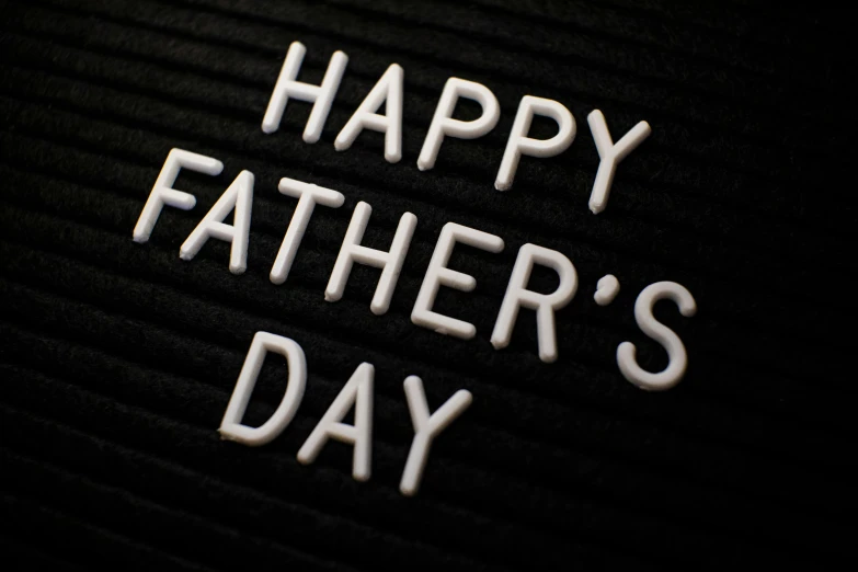 a close up of a sign that says happy father's day, on black paper, 3d printed, thumbnail, men