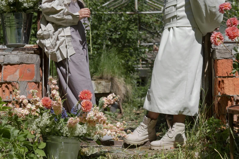 a couple of men standing next to each other in a garden, by Helen Stevenson, unsplash, renaissance, platform boots, wearing off - white style, japanese shibari with flowers, muted and pastel shades