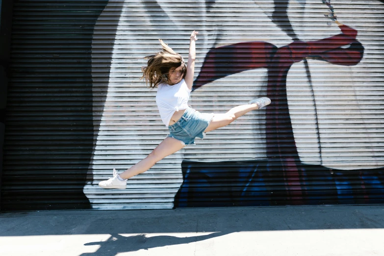 a girl jumping in the air with a skateboard, inspired by Elizabeth Polunin, pexels contest winner, graffiti, wearing white leotard, sydney hanson, wearing a tee shirt and combats, isabela moner