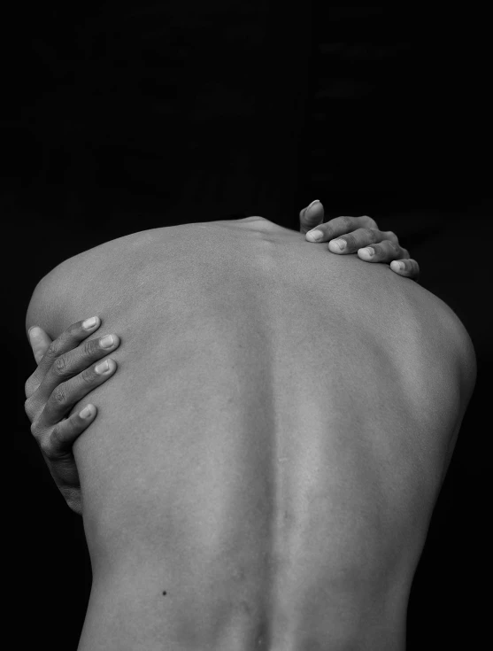 a black and white photo of a woman's back, inspired by Robert Mapplethorpe, hands of men, recovering from pain, maxim sukharev, by greg rutkowski