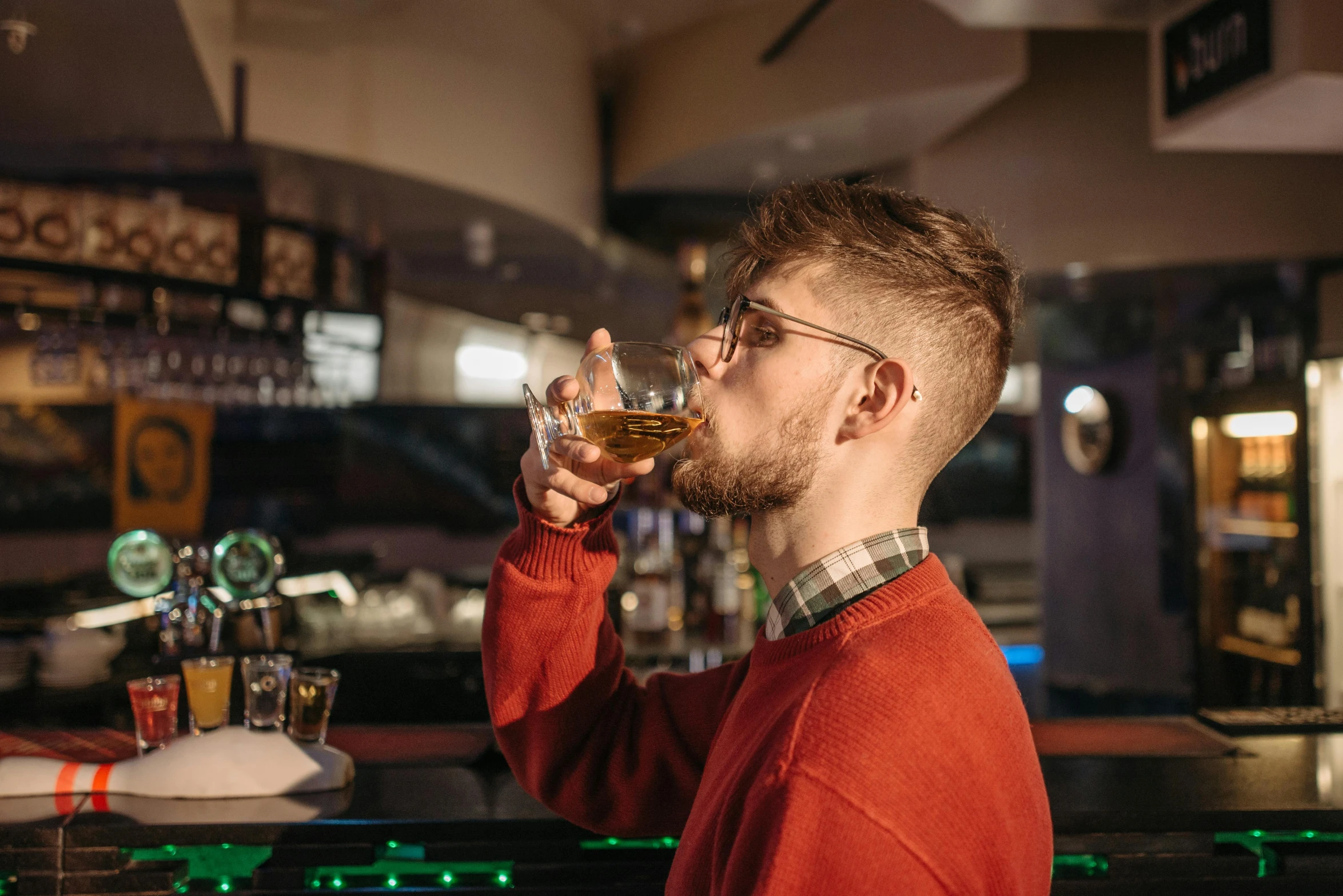 a man drinking a glass of beer at a bar, pexels contest winner, renaissance, ginger bearded man with glasses, 1 9 year old, a blond, whisky