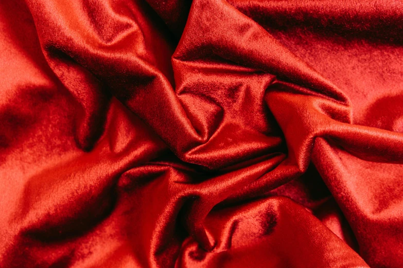 a close up of a red satin fabric, by Julia Pishtar, velvet couch, product shot, metallic, starry