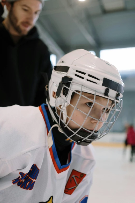 a young hockey player sitting on the ice, trending on unsplash, headshot, documentary footage, full frame image