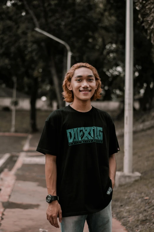 a young man standing on a sidewalk with a skateboard, inspired by Patrick Ching, pexels contest winner, graffiti, in a dark teal polo shirt, set on singaporean aesthetic, discord profile picture, wearing a black!! t - shirt