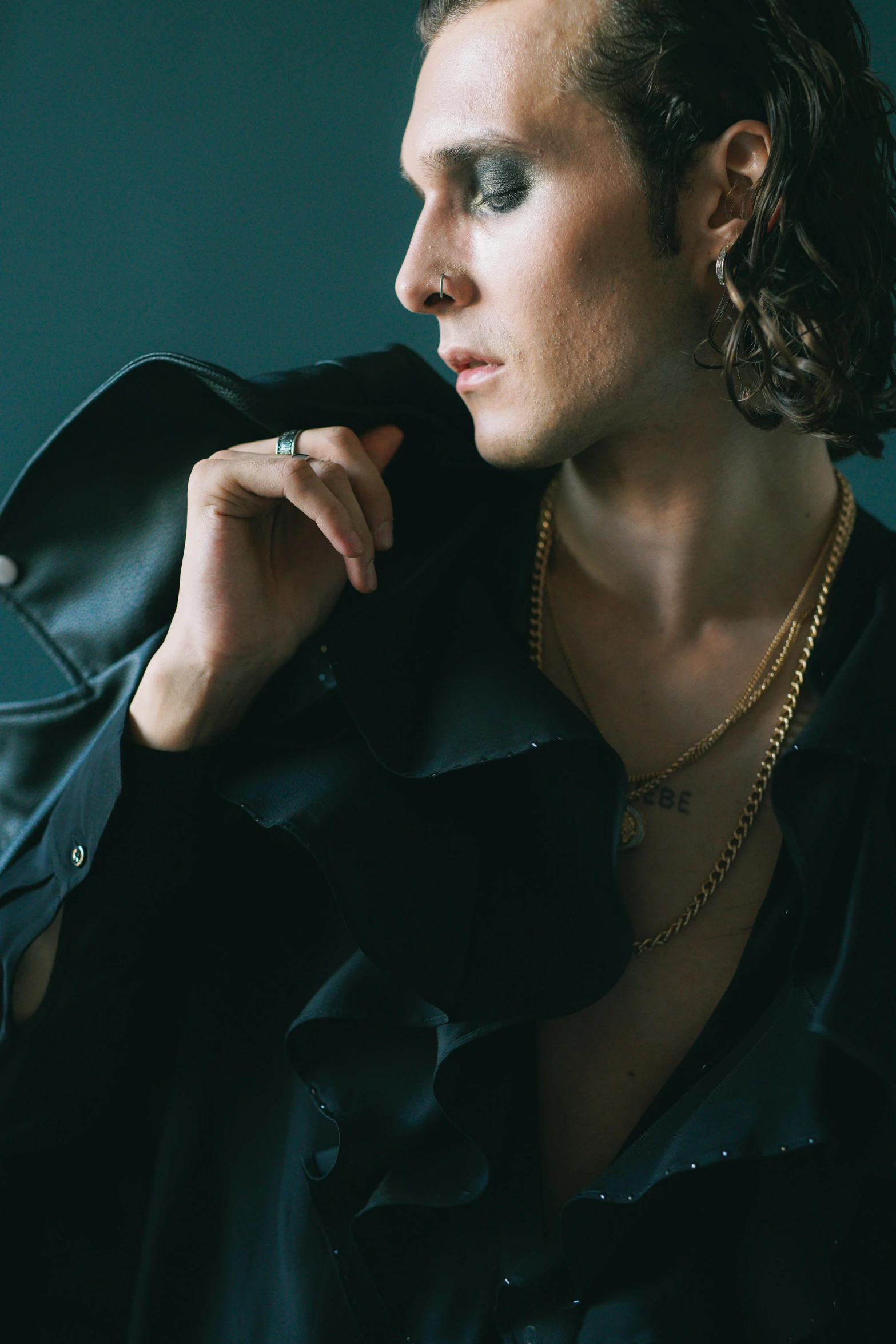 a close up of a person wearing a jacket, inspired by Elsa Bleda, robert sheehan, gold chain necklace, delicate androgynous prince, leather jewelry