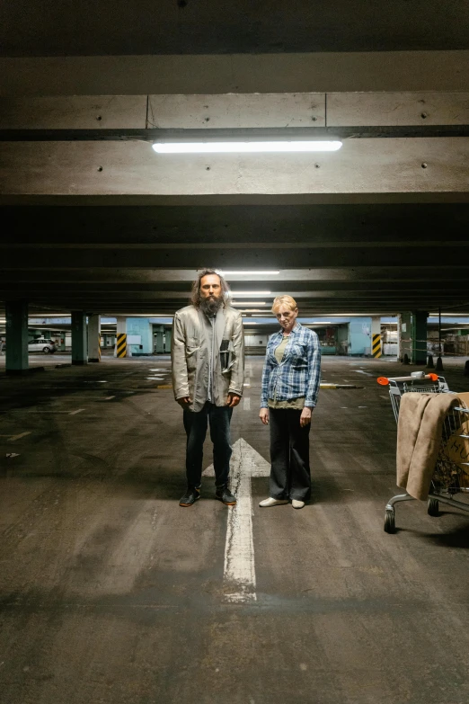 two people standing in an empty parking garage, a portrait, the big lebowski, die antwoord, promotional image, hunters