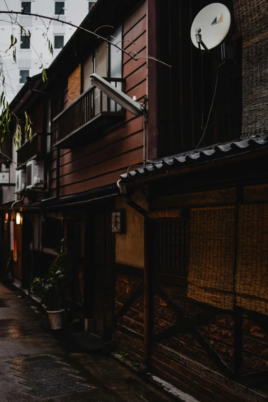 a couple of people that are walking down a street, inspired by Kanō Hōgai, unsplash contest winner, dimly lit cozy tavern, empty buildings with vegetation, day after raining, preserved historical