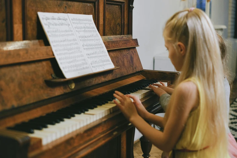 a little girl that is playing a piano, pexels, danube school, profile image, thumbnail, in a medium full shot, high quality artwork