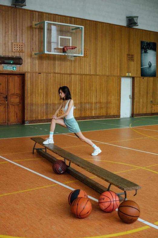 a young girl standing on top of a wooden bench, dribble, jackie tsai style, sports setting, julia hetta, kano)