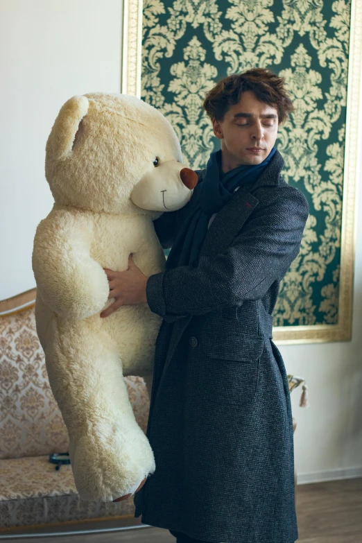 a man standing next to a giant teddy bear, an album cover, inspired by Illarion Pryanishnikov, riccardo scamarcio, at a fashion shoot, promotional image, private moment