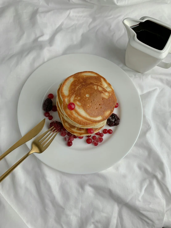 a white plate topped with a stack of pancakes next to a cup of coffee, by Eleanor Best, low quality photo, sakimichan, “berries, gif