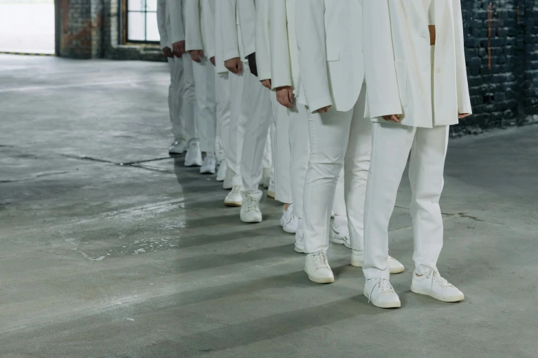 a group of men standing next to each other, inspired by Vanessa Beecroft, pexels contest winner, antipodeans, wearing white sneakers, lined up horizontally, platinum attire, linen