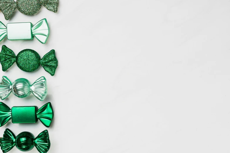 a number of different types of bows on a white surface, an album cover, by Emma Andijewska, trending on pexels, minimalism, emerald, background image, glitter gif, 8k octan photo