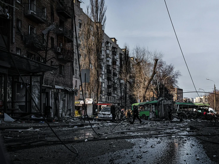 a bus that is sitting on the side of a road, by Lucia Peka, pexels contest winner, hyperrealism, volodymyr zelensky at war, city destruction, wires hanging above street, 000 — википедия