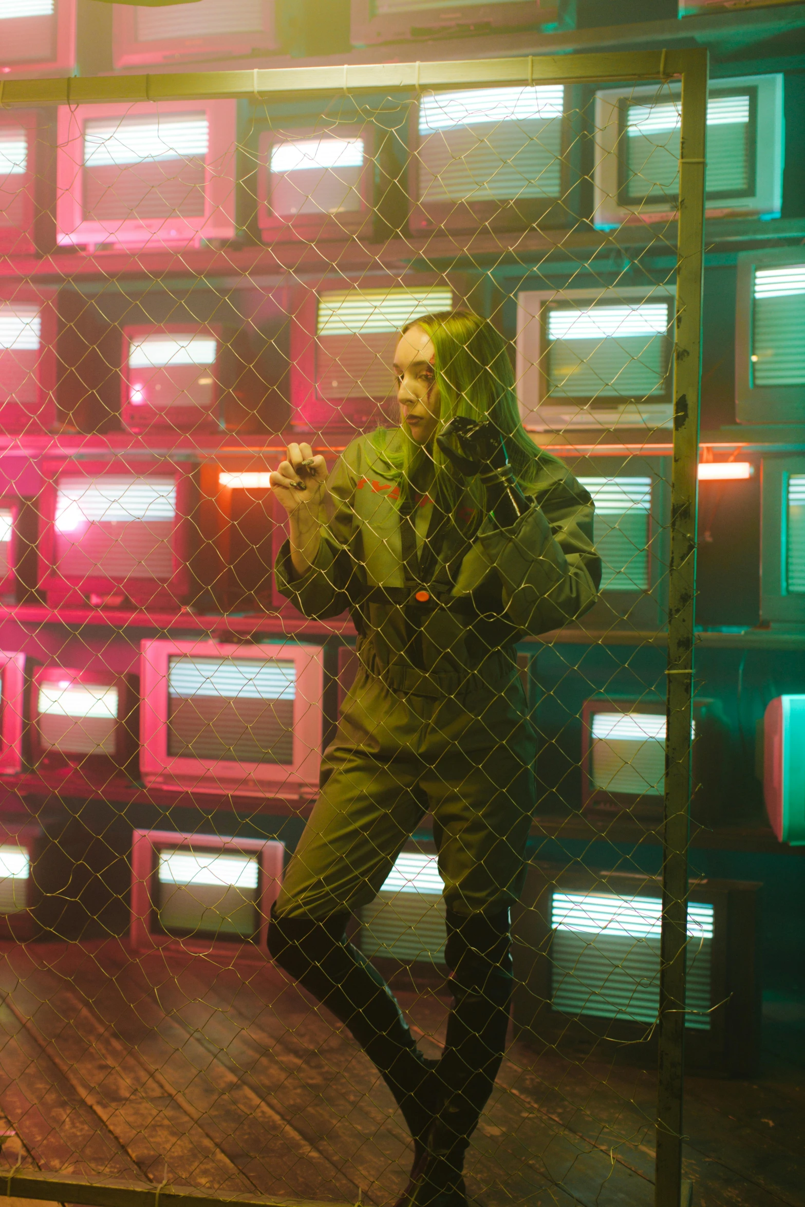 a man standing in front of a wall of televisions, cyberpunk art, inspired by Liam Wong, conceptual art, photograph of a techwear woman, press shot, grimes, hexglow