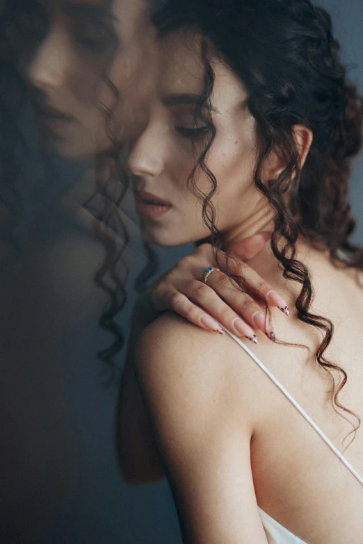 a woman with curly hair standing in front of a mirror, inspired by Elsa Bleda, trending on pexels, renaissance, curved. studio lighting, hair floating covering chest, over the shoulder closeup, loving embrace