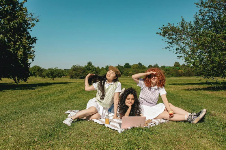 a group of women sitting on top of a lush green field, an album cover, trending on pexels, magic realism, dressed as schoolgirl, eating outside, document photo, on a sunny day