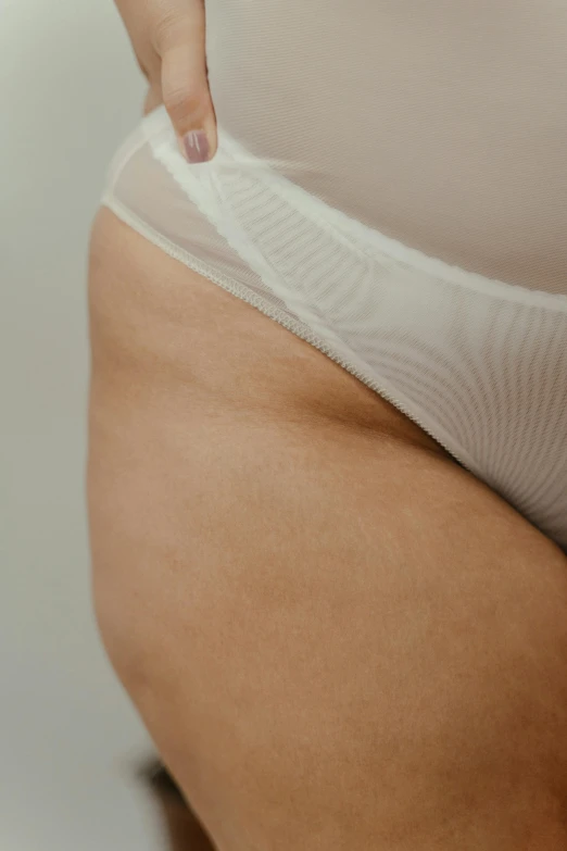 a close up of a person in a white underwear, thick and thin lines, half body shot, detailed product image, bloated