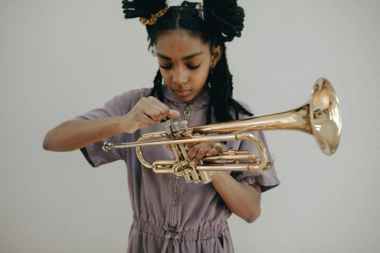 a girl in a purple dress playing a trumpet, pexels contest winner, black arts movement, willow smith young, brass equipment and computers, carefully crafted, schools