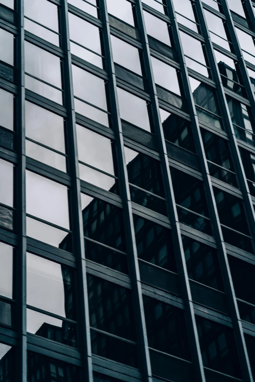 a traffic light hanging from the side of a tall building, pexels contest winner, modernism, black windows, buildings covered in black tar, highly reflective surface, office building