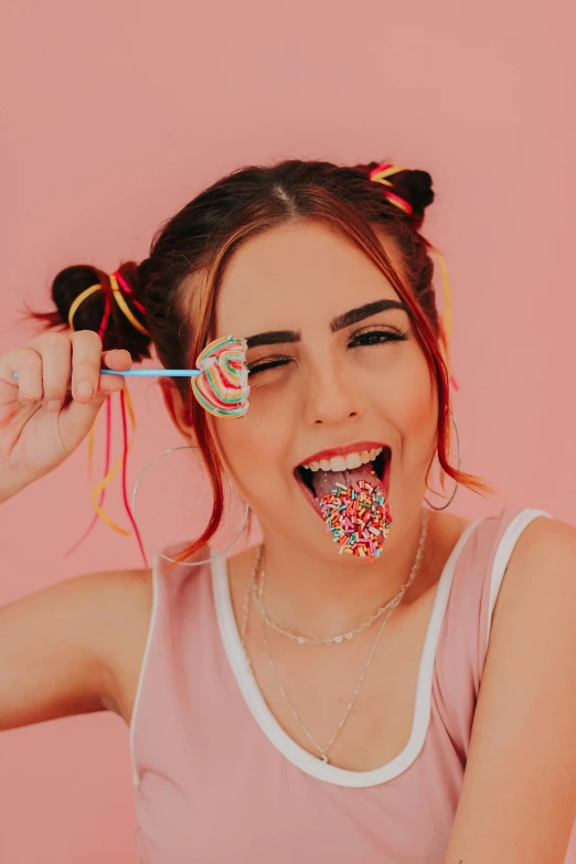 a woman holding two lollipops in front of her face, trending on pexels, eating noodles, madison beer, wearing a pink head band, snake tongue