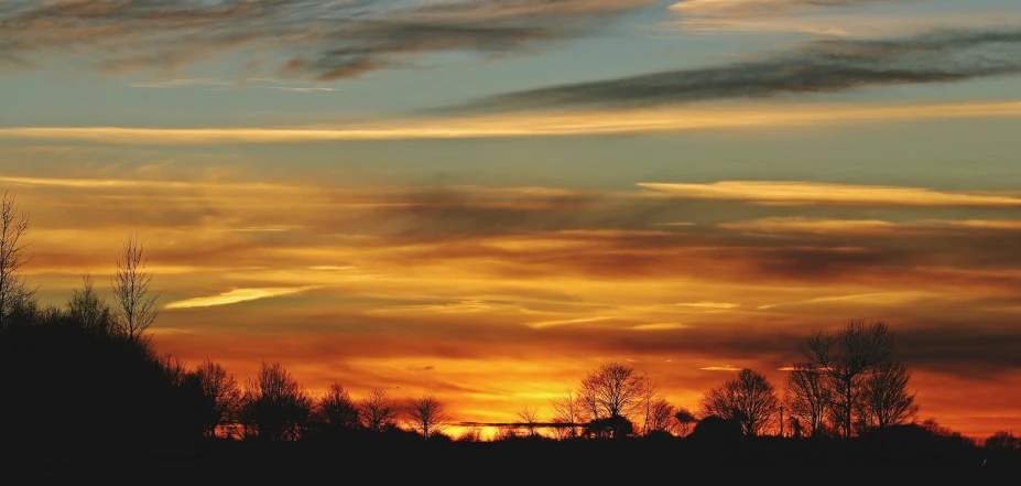 a plane flying in the sky at sunset, by Ian Fairweather, pexels contest winner, romanticism, winter vibrancy, fine art print, skyscape, silhouetted