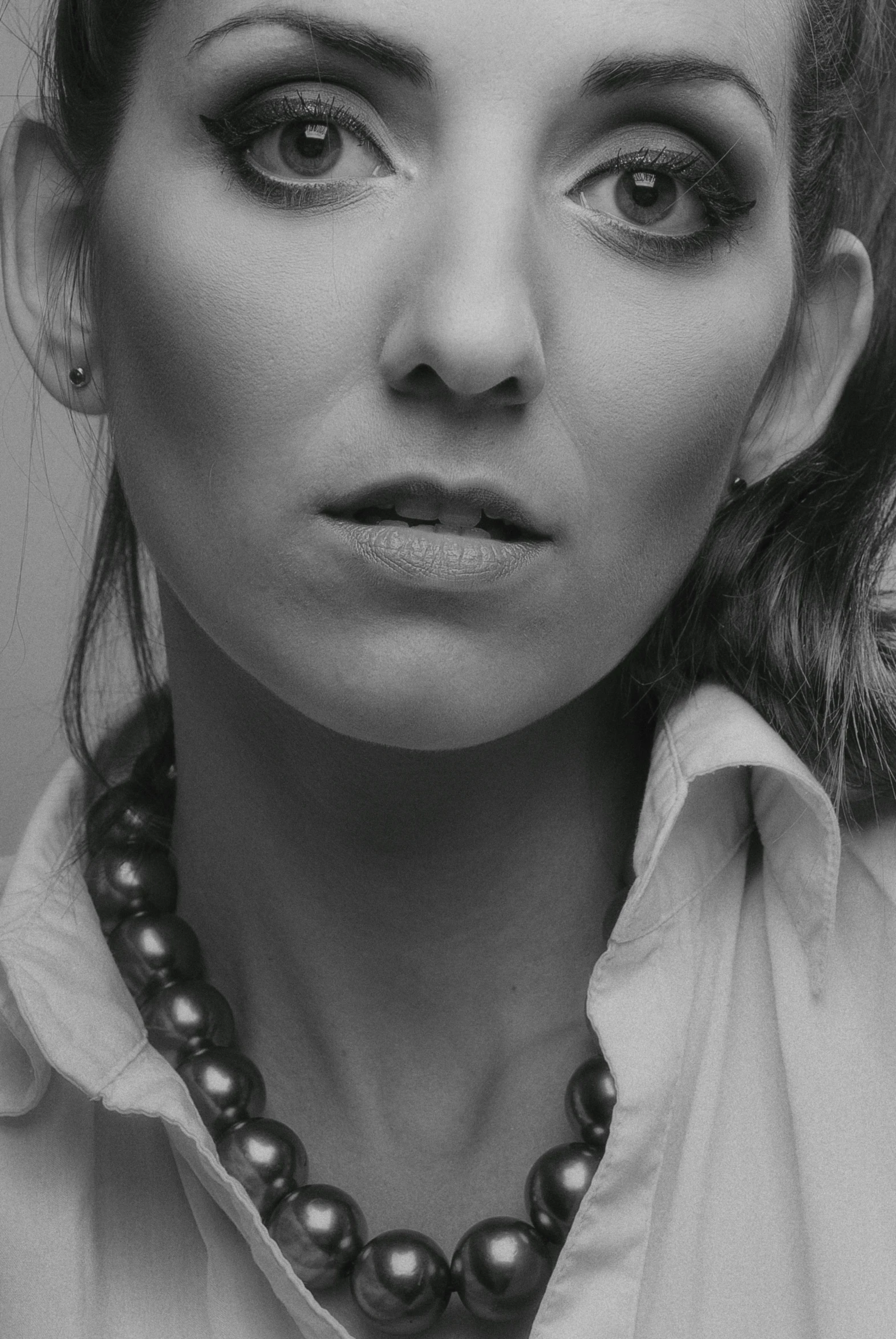 a black and white photo of a woman, inspired by irakli nadar, unsplash, photorealism, wearing jewellery, semi - realistic render, ultrarealistic photography, low - angle shot